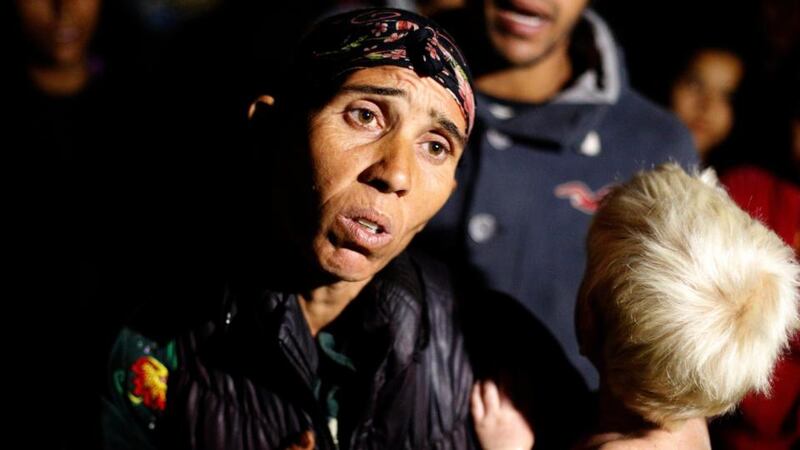 Bulgarian Roma Sasha Ruseva holds her son Atanas as she speaks to media yesterday outside her house in the town of Nikolaevo, some 280km  east of Sofia. Photograph: Stoyan Nenov/Reuters
