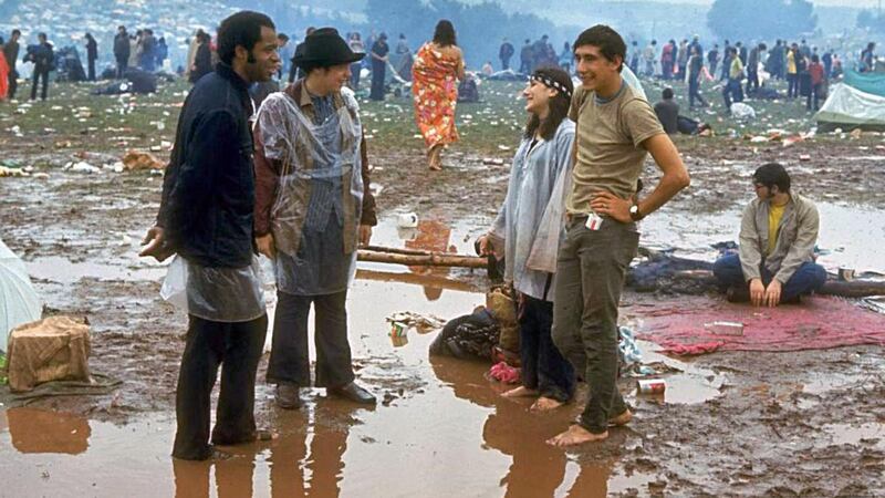 “Young people standing in the mud & water talking, during the Woodstock Music & Art Fair.” Photograph:  John Dominis/LIFE Picture Collection/Getty Images
