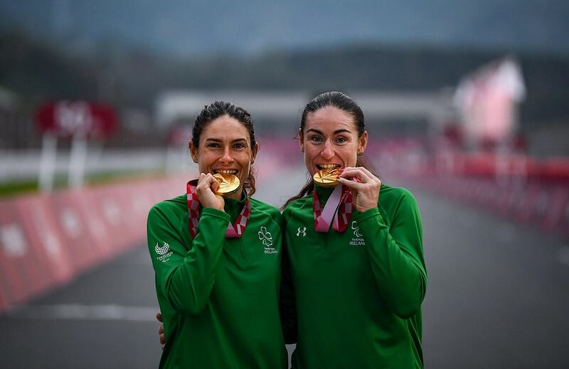 Katie-George Dunlevy and Eve McCrystal celebrate with their gold medals following the Women’s B Time Trial at the Paralympic Games in Tokyo. Photograph: David Fitzgerald/Sportsfile