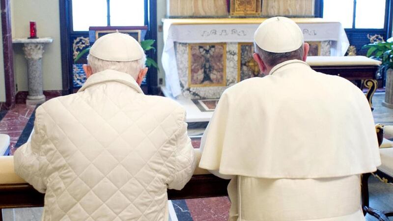 Pope Francis and his predecessor, Pope Emeritus Benedict XVI, pray together at the papal summer residence Castel Gandolfo  near Rome. Photograph: Servizio Fotografico L'Osservatore Romano via Getty Images