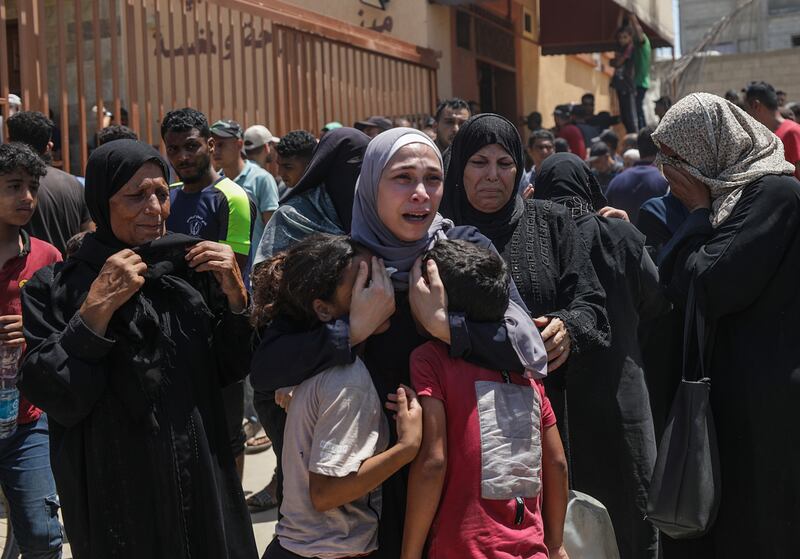 A Palestinian woman mourns with her children after her husband was killed in an Israeli air strike in the Al-Mawasi area of Khan Younis on July 13th. Photograph: Mohammed Saber/EPA