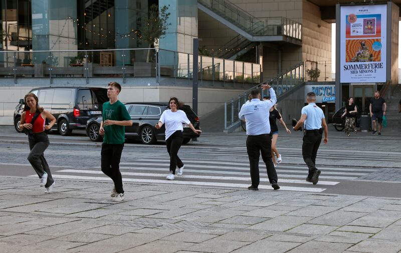 Emergency  personnel direct people as they run from the Field's shopping centre in Copenhagen. Photograph: Olafur Steinar Gestsson /Ritzau Scanpix via AP