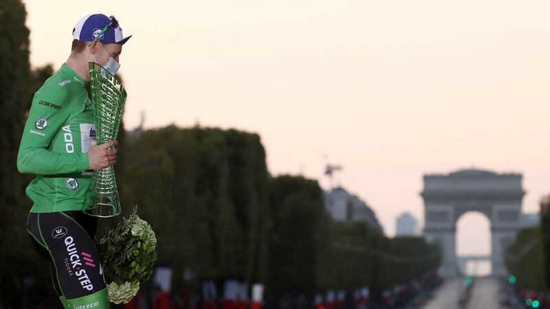 Team Deceuninck rider Ireland’s Sam Bennett celebrates on the podium after winning the best sprinter’s green jersey  on the Champs Élysées. Photograph: Kenzo Tribouillard/AFP/Getty Images