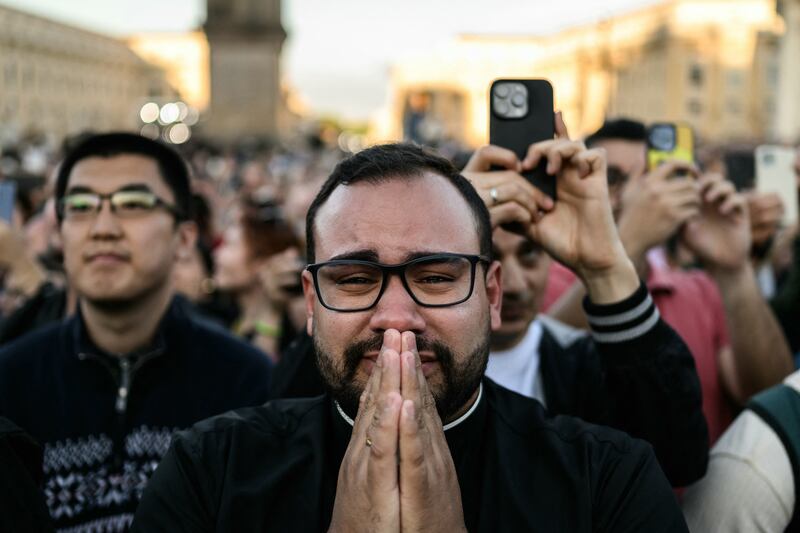 A man reacts as the newly elected Pope Leo XIV, Robert Prevost making his first appearance in the main central loggia balcony of the St Peter's Basilica. Photograph: Jeff Pachoud/AFP via Getty Images