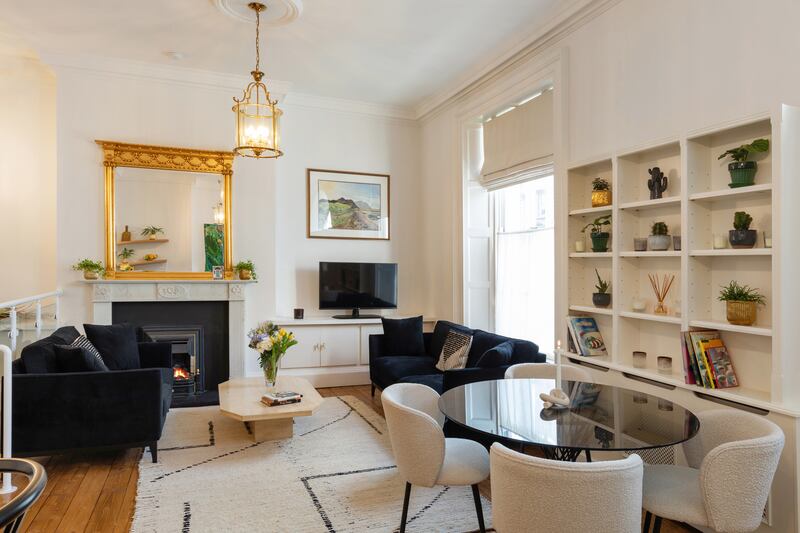 Period details include a marble fireplace, high ceiliing, sash windows and cornicing