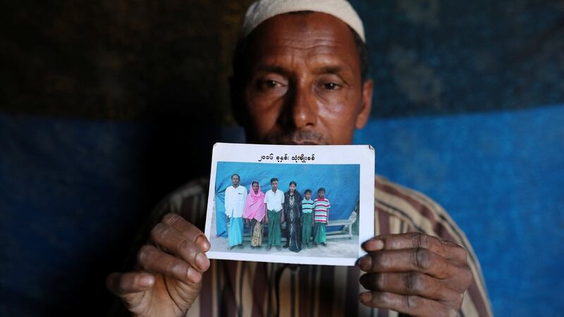 Abdu Shakur, whose son Rashid Ahmed was among 10 Rohingya men killed by Myanmar security forces and Buddhist villagers on September 2nd, holding a family photograph at Kutupalong camp in Cox’s Bazar, Bangladesh. Photograph: Mohammad Ponir Hossain/Reuters