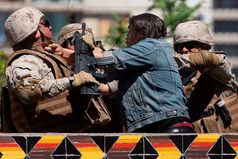Chilean soldiers detain a demonstrator in Santiago, Chile on October 21st. Photograph: Claudio Reyes/AFP/Getty