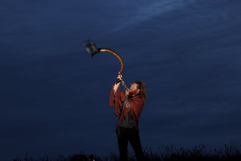 Dean Stapleton from Finglas heralding the summer solstice under the moonlight on the Hill of Tara. Photograph: Alan Betson 
