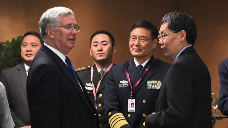 Britain secretary of state for defence Michael Fallon (left) mingles with Sun Jianguo (centre) from the Chinese People’s Liberation Army Navy, and Singapore Minister for Transport and second minister for defence. Photograph: Getty