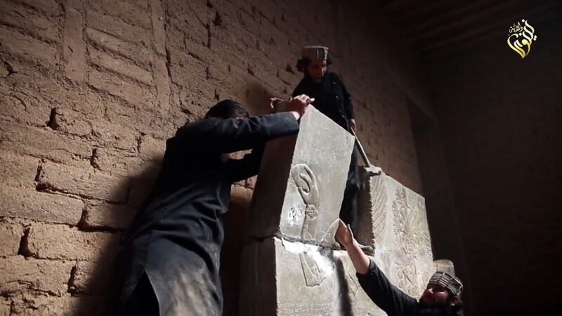 This file image grab taken from a video made available by Jihadist media outlet Welayat Nineveh on April 11, 2015, allegedly shows members of the Islamic State militant group destroying a stoneslab with a sledgehammer at what they said was the ancient Assyrian city of Nimrud in northern Iraq. Photograph: AFP/Getty Images