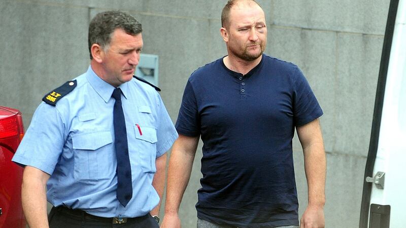 Thomas McInerney leaving Tullamore District Court with a garda  in connection with an investigation into theft and related offences in the areas of Laois, Offaly, Tipperary, Carlow and Kilkenny. Photograph: James Flynn/APX