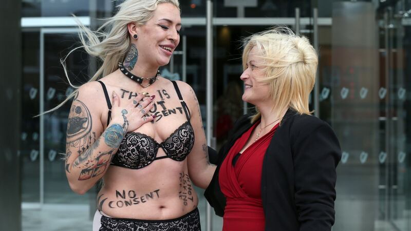 Leona O’Callaghan (right) hugs consent protester Stacie Ellen Murphy outside the Central Criminal Court in Dublin on Monday after Patrick O’Dea (52) of Pike Avenue, Limerick, was sentenced to 17 years for her rape and sexual assault on dates in 1994 and 1995.  Photograph: Laura Hutton/Collins