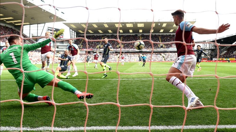 Matthew Lowton can’t prevent Sergio Aguero from scoring Manchester City’s opened at Turf Moor. Photograph: Michael Regan/Getty