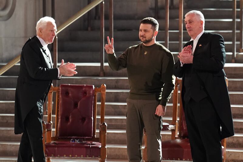 Volodymyr Zelenskyy makes the V for Victory sign as he is applauded by speaker of Britain's House of Lords, Lord McFall (left) , and the speaker of the House of Commons, Sir Lindsay Hoyle (right). Photograph: Stefan Rousseau - Pool/Getty Images