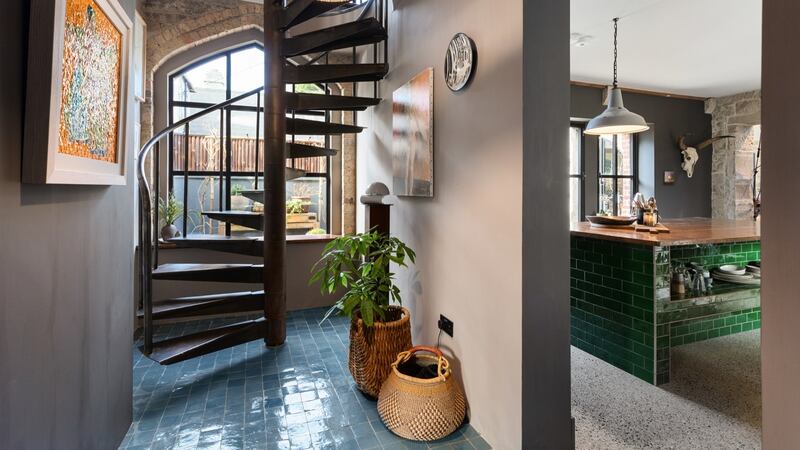 A full-size, raw-steel, custom spiral staircase winds up to the first floor at Glandore Mews in Monkstown, Co Dublin