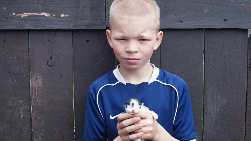 Liam Doran poses with a kitten  in 2012