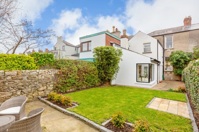 The back garden is set out mainly in lawn 