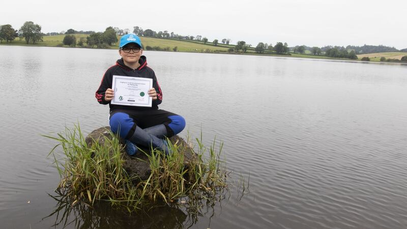 Kian Ferguson (12) proudly displays his certificate following the Try Fishing event