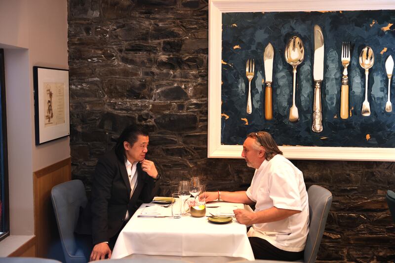 Kevin Hui owner of China Sichuan, relaxing in Pearl Brasserie, Merrion Street, with chef-patron Sebastien Masi. Photograph: Dara Mac Dónaill








