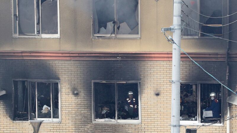 Firefighters and rescue personnel are seen inside an animation company building after it was set on  fire in Kyoto. Photograph: AFP/Getty