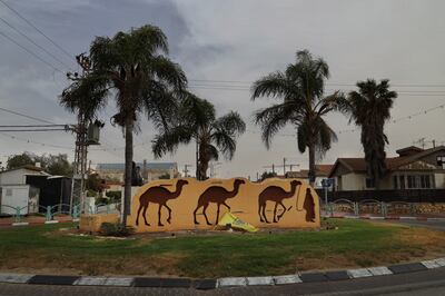 One of the main roundabouts in Dimona features a display depicting a Bedouin with three camels. Israel refuses to classify camels as 'farm animals', preventing Bedouin herders from enjoying grazing rights in the Naqab desert region. Photograph: Hannah McCarthy