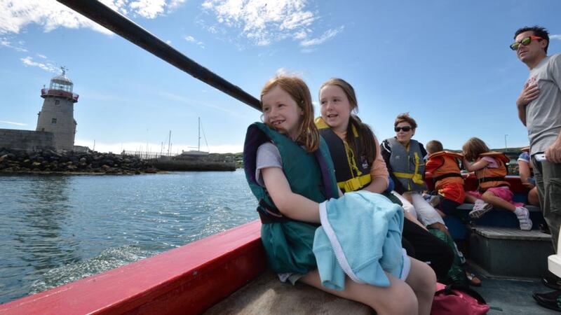 Grace (7) and Ellen (10) with their mother, Pauline O’Shea, on board the boat from Howth. Photograph:  Alan Betson