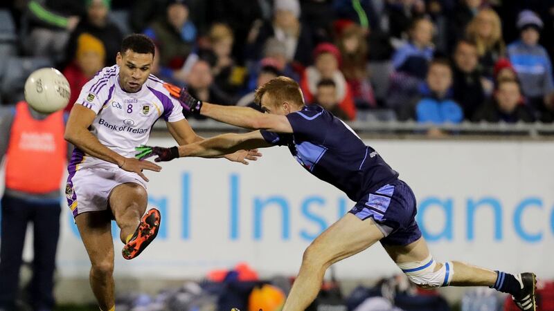 Kilmacud Crokes’ Craig Dias scores a point despite the efforts of Niall O’Shea of St Jude’s during the Dublin SFC Final at Parnell Park. Photograph: Laszlo Geczo/Inpho