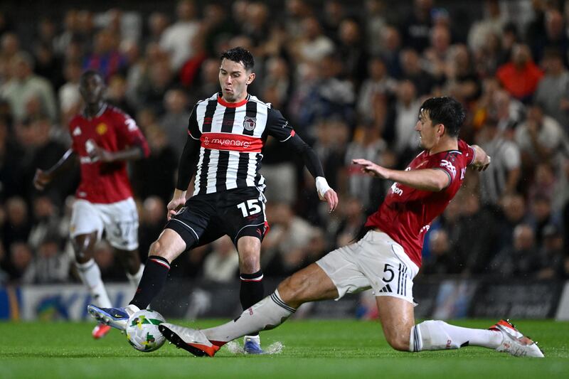 Grimsby's Geza David Turi is challenged by Manchester United's Harry Maguire during the Carabao Cup second round game at Blundell Park last month. Photograph: Shaun Botterill/Getty Images