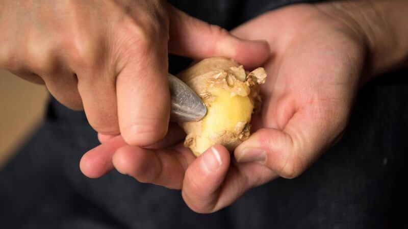 Using a spoon to get into the knobbly bits of ginger. Photograph: Linda Nylind/The Guardian