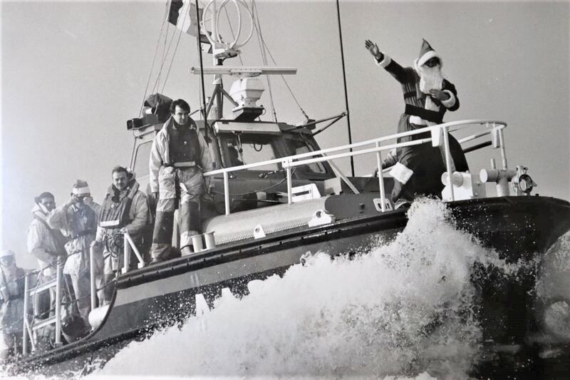 The Dun Laoghaire RNLI lifeboat  delivering a Christmas hamper to the Kish lighthouse keepers  in 1991