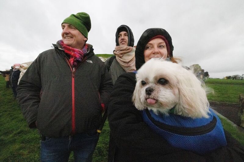 Gizmo (age 13) with his family Neil Casley, Finn Casley and Clelia Murphy from Phibsboro, at Newgrange on the morning of the winter solstice. Photograph: Alan Betson