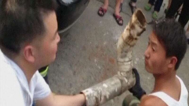 Rescuers try to reach a trapped infant inside a piece of sewage pipe, in this still image taken from video, in Jinhua city, Zhejiang province.China Central Television via REUTERS.