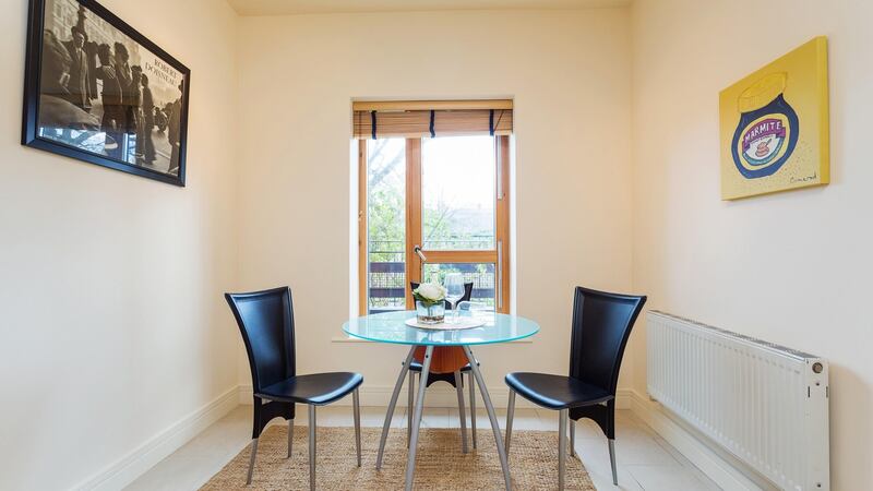 The kitchen table and chairs overlook the water, and  there is scope to install a large table or  built-in banquette seating