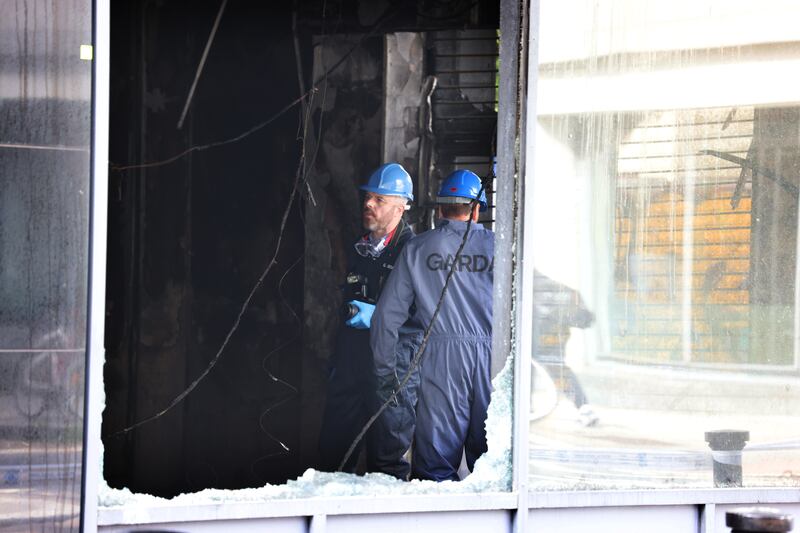 Investigators at the fire damaged Republic of Jiu Jitsu studio. Photograph: Bryan O’Brien