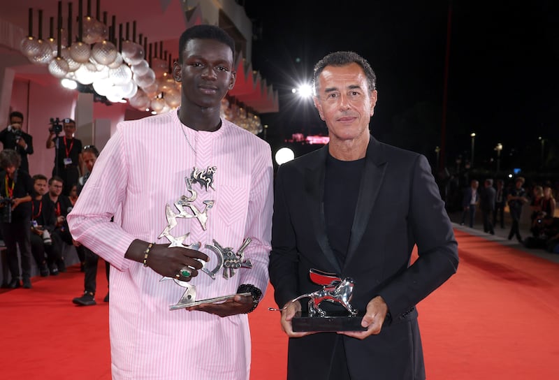 Seydou Sarr and Matteo Garrone at the 80th Venice International Film Festival. Photograph: Pascal Le Segretain/Getty