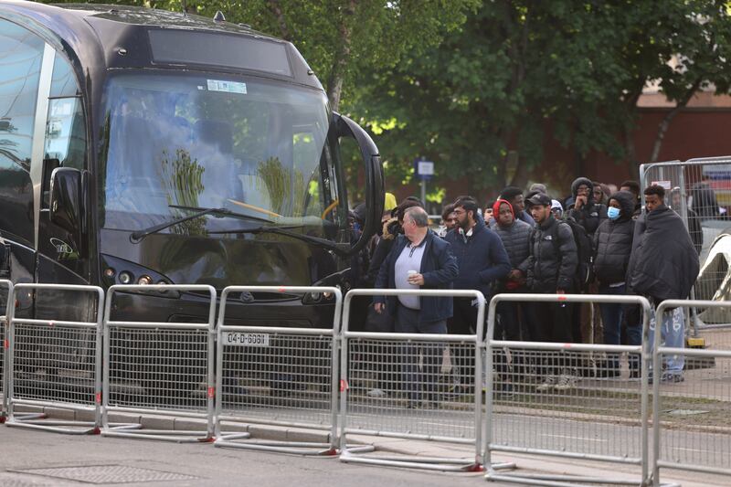 Asylum seekers being loaded onto buses after their tents were removed from the Grand Canal in Dublin. Photograph: Dara Mac Dónaill








