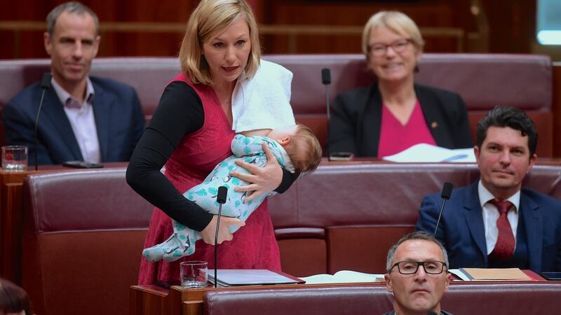 Larissa Waters breastfeeds her daughter Alia Joy as she speaks in  Parliament House in Canberra in June. File photograph: Lukas Coch/via Reuters