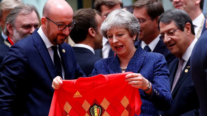 Britain’s prime minister Theresa May receives a Belgium jersey from prime minister Charles Michel at the EU leaders summit in Brussels. Photograph: Francois Lenoir/Reuters