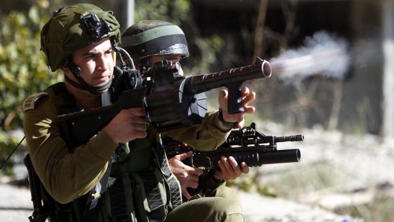 Israeli soldiers fire tear gas grenades towards  Palestinians during clashes in the West Bank city of Hebron following Friday prayers today. Photograph: Abed Al Hashlamoun/EPA.