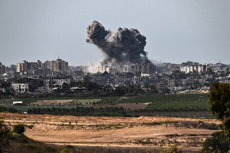 Smoke rises over buildings in the Gaza Strip during an Israeli strike. Photograph: ARIS MESSINIS/AFP via Getty Images