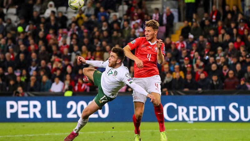 Ireland’s Aaron Connolly with Nico Elvedi of Switzerland.