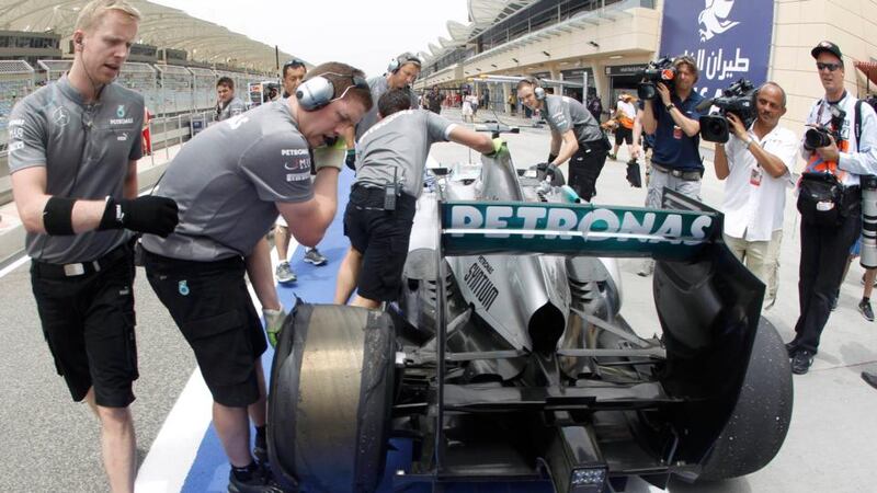 Mercedes mechanics push the car of Lewis Hamilton  in the pits during the third practice session of the Bahrain F1 Grand Prix. Hamilton's hopes of a second successive pole position disappeared on Saturday when he was handed a five-place penalty on the Bahrain Grand Prix starting grid for an unscheduled gearbox change. Photograph: Ahmed Jadallah/Reuters