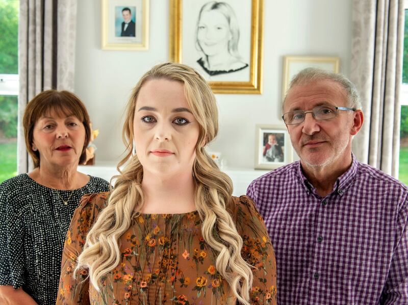 A portrait of Nichola Sweeney hangs behind Sinead O’Leary and Nichola’s parents, Josephine and John. Photograph: Michael Mac Sweeney/Provision