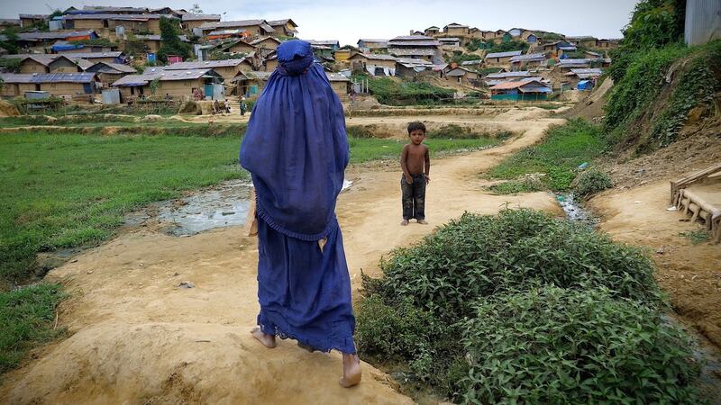 Birth attendant Noor Jahan (60) walking through Jamtoli camp, one of 20 Rohingya refugee camps in the Cox’s Bazar district of southern Bangladesh. Photograph: Kathleen Harris