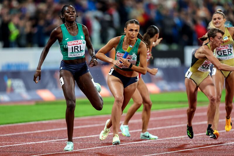 Ireland’s Rhasidat Adeleke hands off to Sharlene Mawdsley during the 2022 European Championships in Munich. Photograph: Morgan Treacy/Inpho 