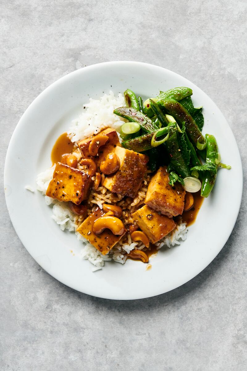Crispy tofu with cashews and blistered snap peas. Photograph:  David Malosh/The New York Times