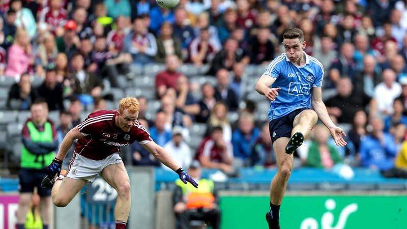 Dublin’s Brian Fenton scores a point as Declan Kyne of Galway fails to get a block in during  the All-Ireland SFC semi-final at Croke Park. Photograph:  Laszlo Geczo/Inpho