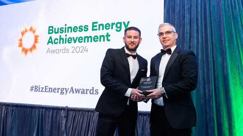 Adam Kane, community lead at BusinessRiver, presents the best energy achievement in public sector award to Charlie Coakley, Uisce Éireann