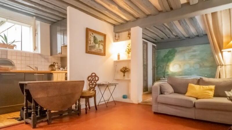 Interiors of this one-bed Parisian apartment are really lovely with original beams overhead