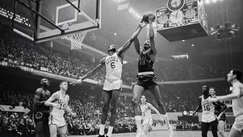 Boston Celtics’ Bill Russell attempts to block Philadelphia 76ers’ Wilt Chamberlain during a game at the Boston Garden in 1975. Photograph: Bettmann